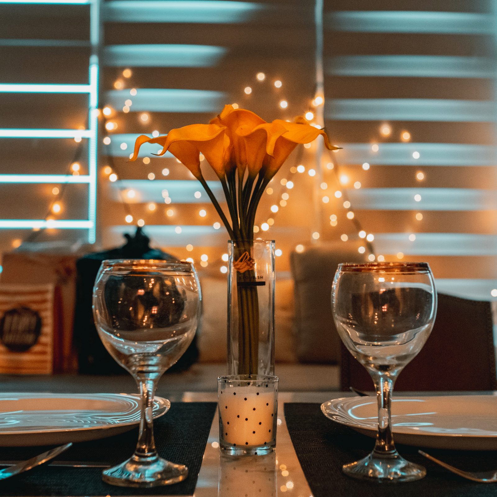 A candlelit dinner table with glasses