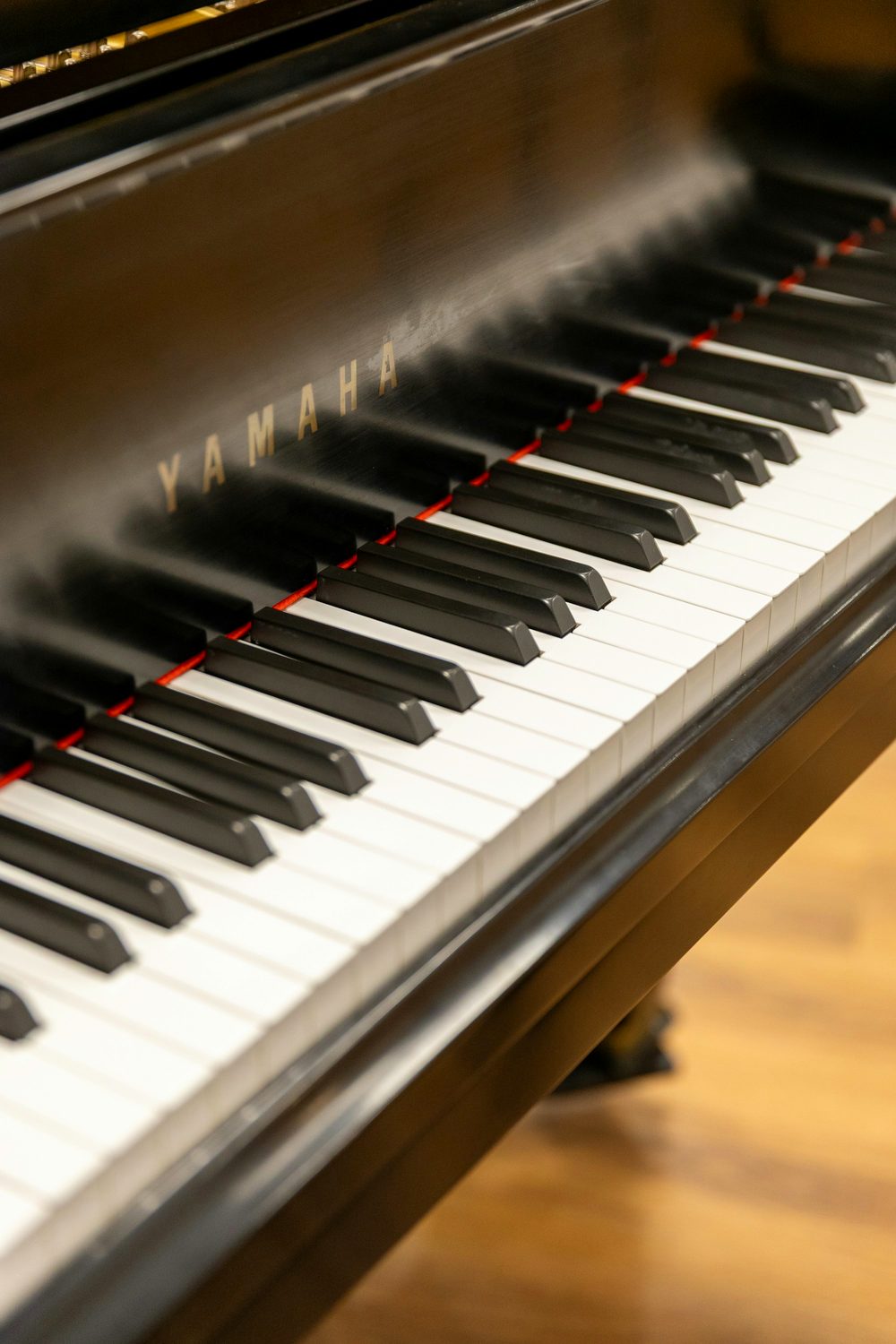 A grand piano with its keys in warm light